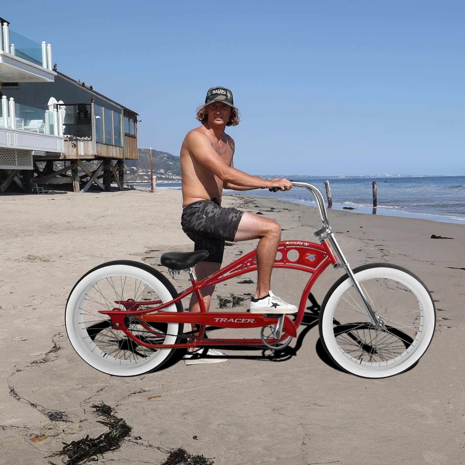 Riding the red Tracer Arcadia GT Beach Cruiser Bicycle on the beach.
