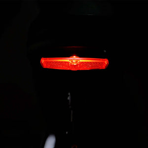 Red rear brake light of Tracer Verge 20" eBike enhances visibility and safety during nighttime rides.